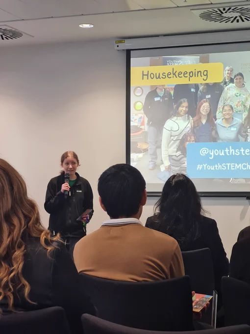 A young person Mhairi standing up at the front and introducing the event to everyone 