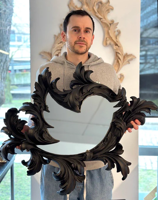 stan katz holding a 3d printed neo-baroque mirror frame inspired by Twitter bird classic logo
