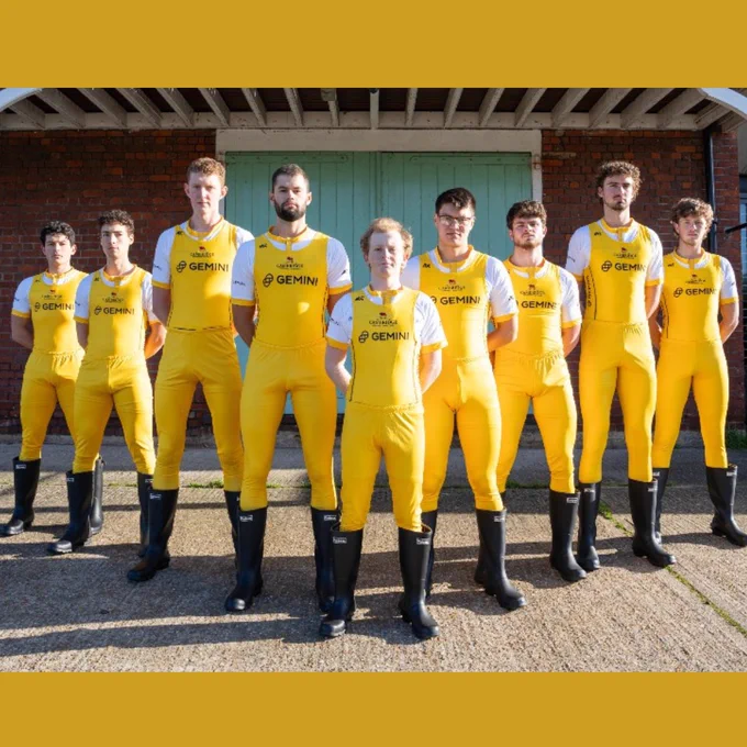 Goldie crew stand together in a v-shape.