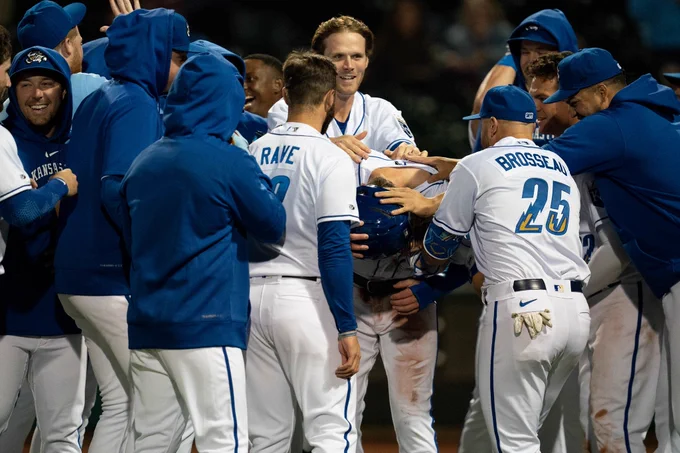 A mob of happy baseball players celebrating a walk off win. 