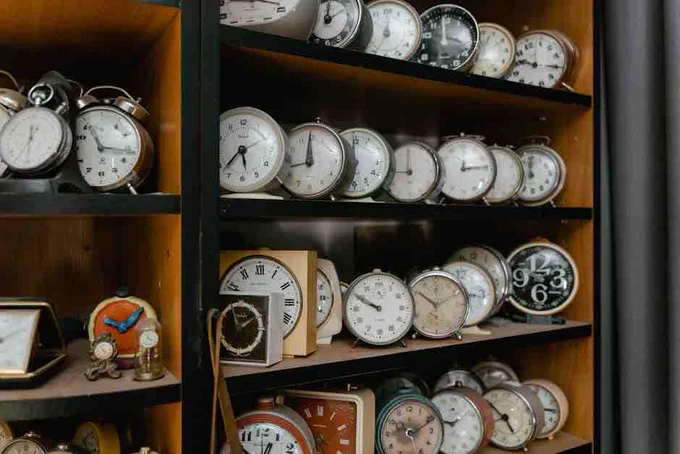 Alarm Clocks on Wooden Shelves