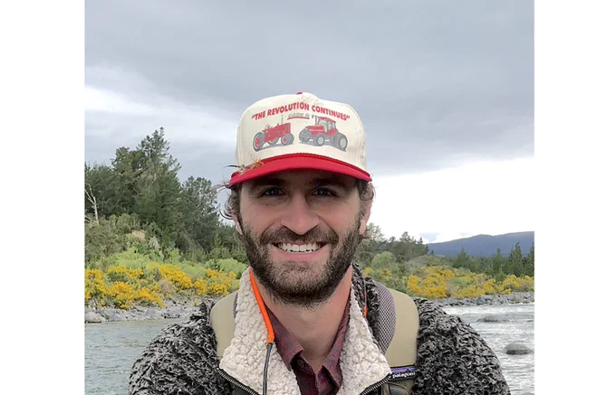 A photo of Brendan Gibbs with a river in the background