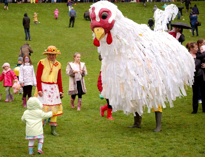 Image of children meeting Plucky the Chicken  at a previous egg rolling event. Photo credit- Laura Cronin 
