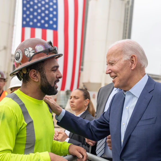 President Joe Biden greets workers after delivering remarks on Infrastructure Act investments at the Metro D Line extension transit project site.