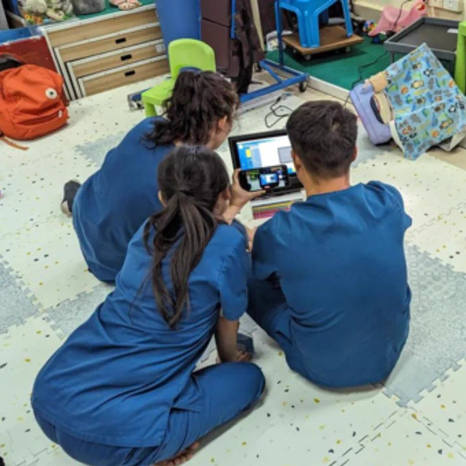 Staff at the Lao Friends Hospital for Children taking a picture of a Grid Pad 12.

