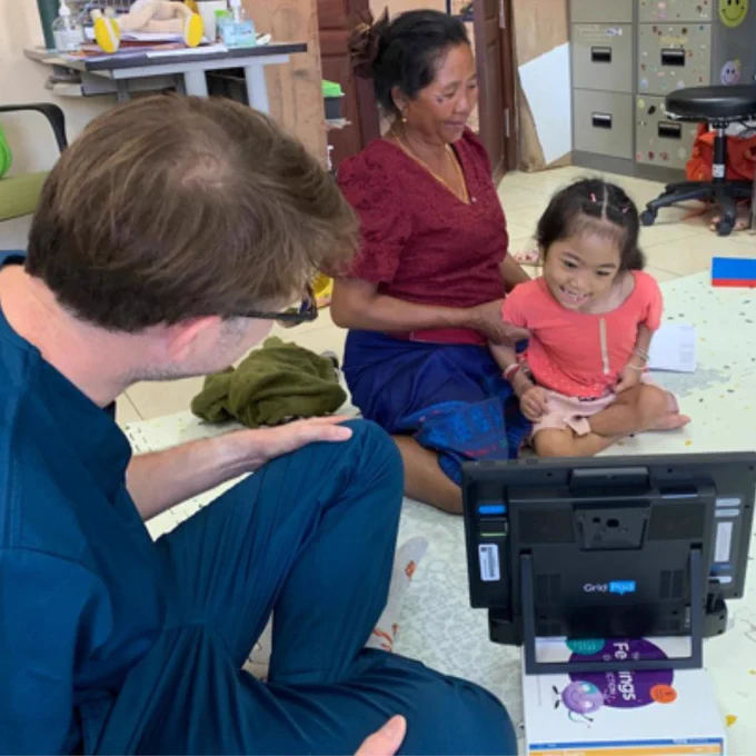 Charlie Danger with a young girl and her Grandmother, looking at a Grid Pad 12.