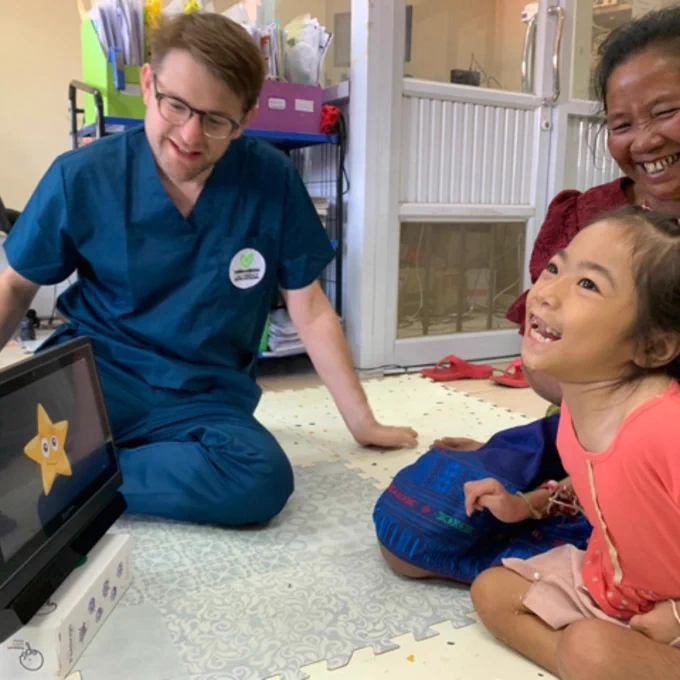 Charlie Danger, a young girl and her Grandmother playing Look to Learn on a Grid Pad 12.