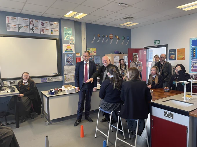 Education Minister Paul Givan pictured with pupils and staff in the school’s science lab