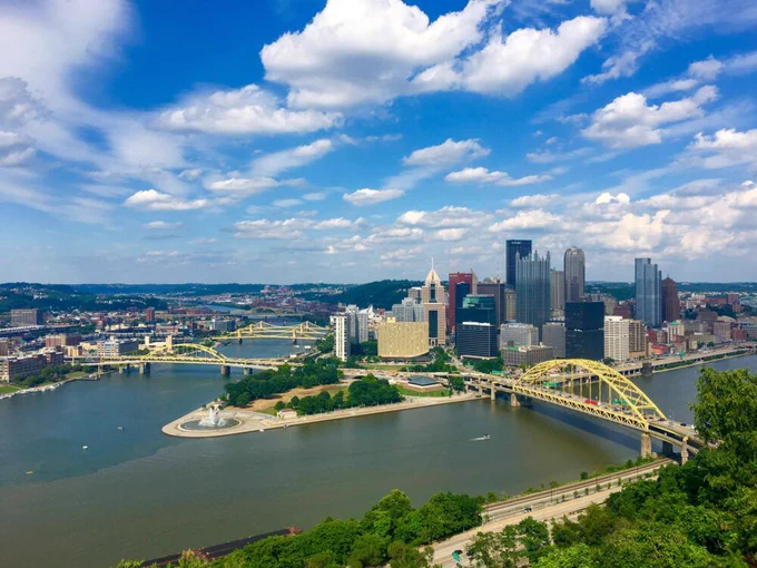 A downtown skyline surrounded by two rivers and several bridges.