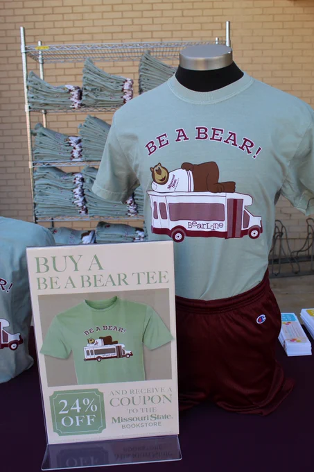 Close up of the new 2024 Be A Bear t-shirt alongside a poster stating when you buy the t-shirt you get a 24% off coupon 