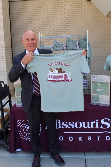 Vice President for University Advancement, Brent Dunn holding the new 2024 Be A Bear t-shirt 