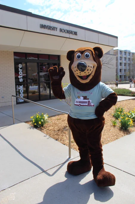 Boomer the bear mascot wearing the new 2024 Be A Bear t-shirt in front of the MSU Bookstore.