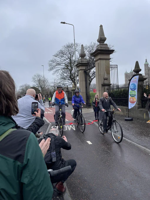 Photo of official opening of CCWEL with Patrick Harvie, Scott Arthur, Claire Daly from Sustrans and local school kids cycling.