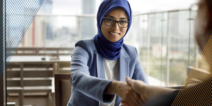 A woman shaking hands with someone.