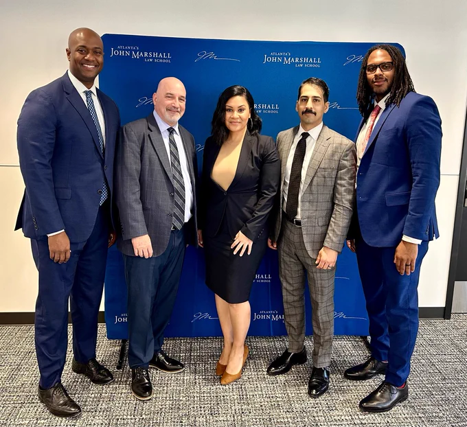 Director Rossi, ATJ staff and US Attorney Buchanan (Georgia) pose in front of step and repeat. 