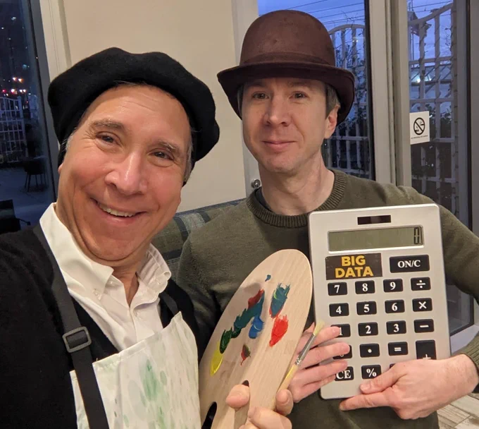Joint selfie; Mark in painter's outfit, Neil in a hat with a giant calculator labelled Big Data.