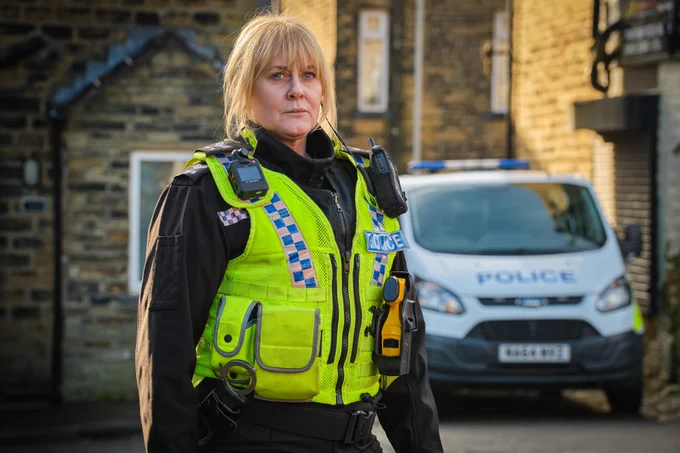 Photo featuring Sarah Lancashire as Catherine Cawood in Happy Valley wearing police uniform.