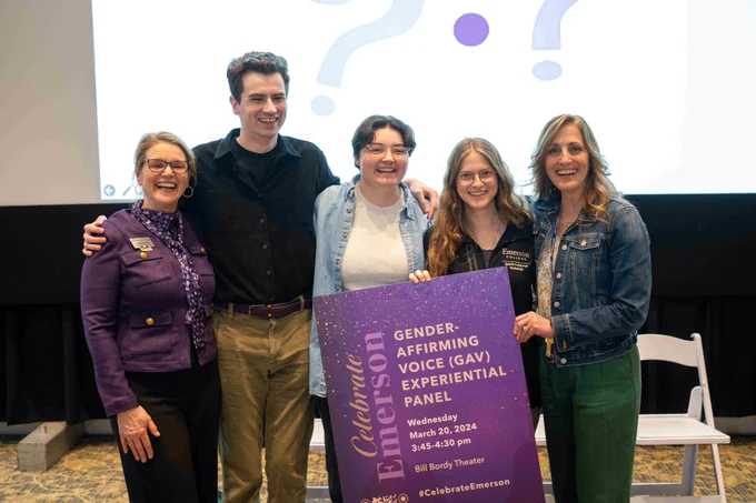 People smile for a photo, holding a board with the words "Gender-affirming voice (GAV) experiential panel" in bold letters, next to "Celebrate Emerson" words.