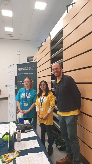 Picture of our volunteers standing behind our Cambridge festival table. 