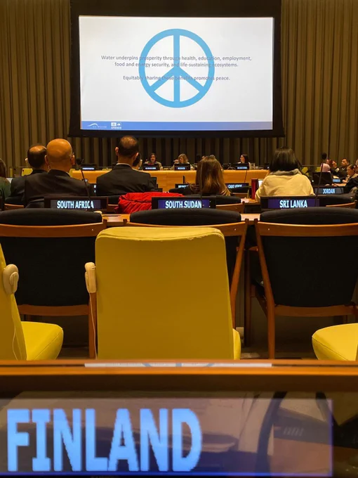 Photo reflected on screen at the UN with the peace symbol and the following text:

Water underpins prosperity through health, education, employment, food and energy security, and life-sustaining ecosystems.
Equitably sharing the se benefits promotes peace.