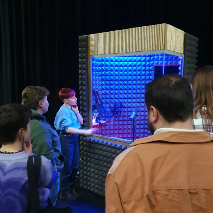 Gemma from Action Hero shows us the sound booth she performs from. It's covered in acoustic foam and dramatically lit.