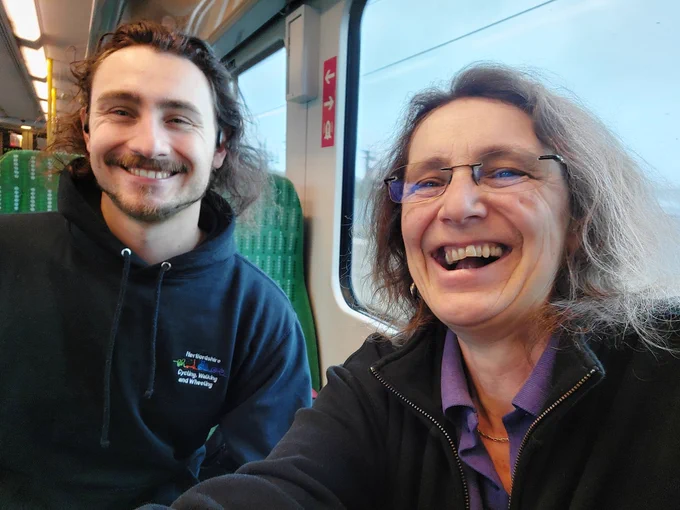 Sam and Tina on a train (left to right)