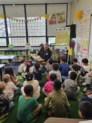 Image of Commissioner Tom DiBello reading to children 