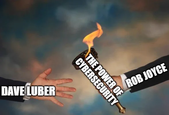 Meme of a man's arm labeled "Rob Joyce" passing off a torch labeled "the power of cybersecurity" to another man's arm labeled "Dave Luber"