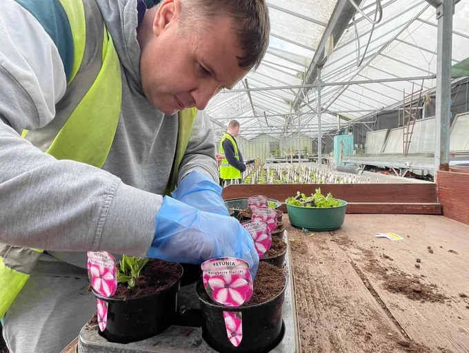 A Heaton Fold student planting plugs into pots ready for public sale in a few weeks.