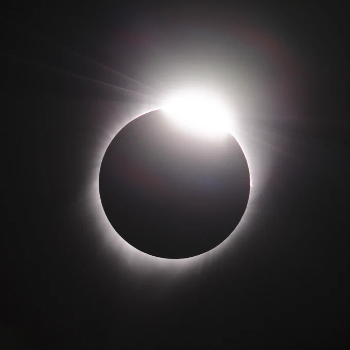 The darkness of space covering the entire image. At the center the Moon looks like a dark circle covering the Sun with its rays peeking out from the edges. This image taken at 10:19:24 on August 21, 2017 as Oregon begins to see first light 'diamond' following totality. Photographer: Dominic Hart