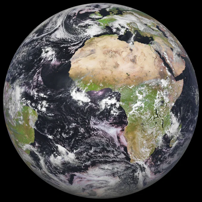 Image of full globe Earth captured by MSG-4 (the fourth satellite in the Meteosat Second Generation) on 22 April 2022. Continent of Africa, parts of South America, Europe and Middle East visible with browns and greens, surrounded by dark blue oceans and white cloud patterns, seen against blackness of space.