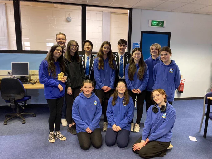 Marcus Flucker MSYP and Ella Quinn MSYP smiling for a photo with the judges of the Angus Schools Debate Competition and the MHS Junior Debate Club.