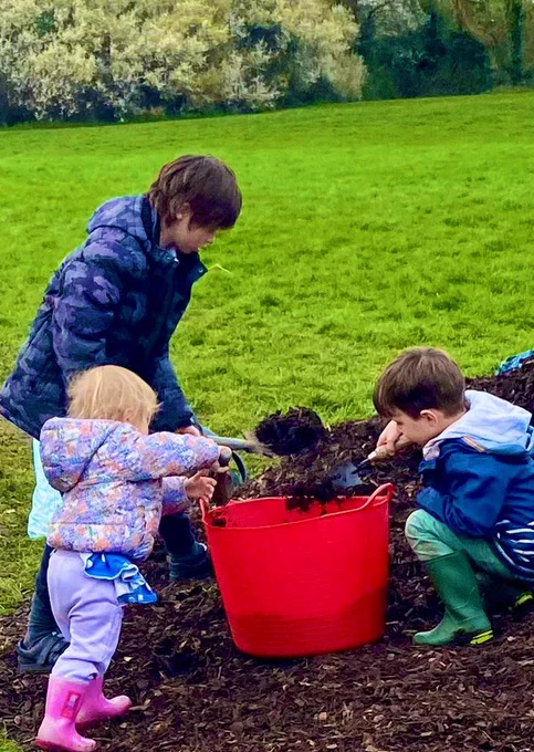 The fab squad working to get the mulch ready to bed in the saplings