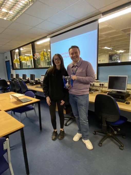 Ella Quinn and Marcus Flucker holding the “Angus Schools Debating Competition” trophy.