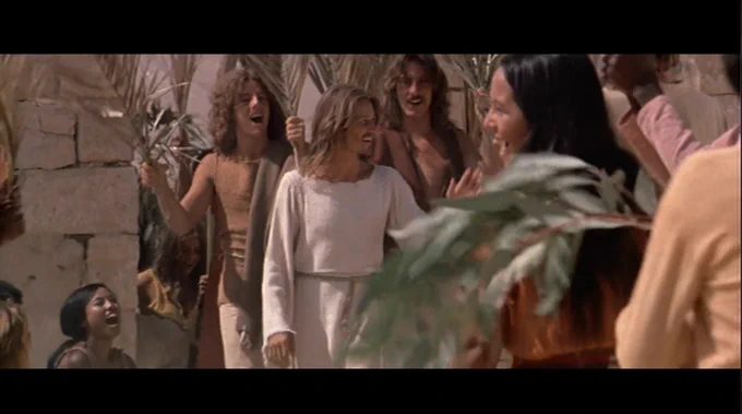 Still frame from "Hosanna", a song from the move "Jesus Christ Superstar" (1973). It shows Jesus' triumphant entry into Jerusalem, being greeted with palm branches by the crowds.