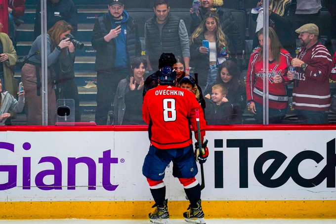 Alex Ovechkin greets his kids at the glass. 