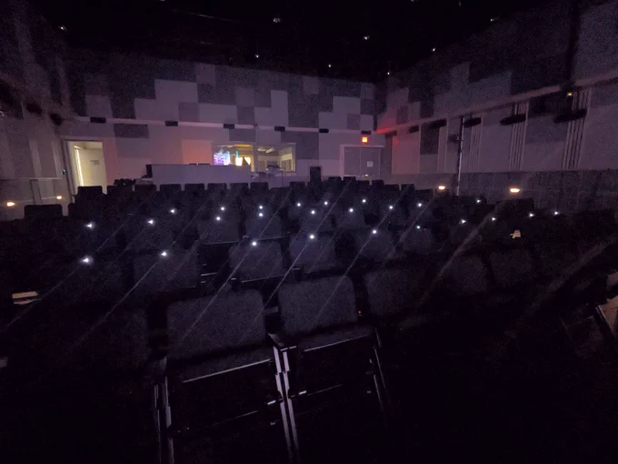 A view of a concert hall with the lights low and mobile eye-tracking devices illuminated at 30 seats