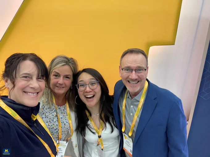 MLabs team members Kelly LaBarge, Jackie Goodman, and Steve Gregg pose with Dr. Madelyn Lew at the MLabs booth at USCAP 2024.