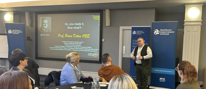 Professor Brian Dolan is pictured presenting to the audience.
