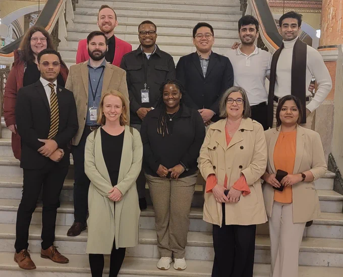 Alt text: Image of Illinois Science Policy Program Scholars and Policy & Research Legislative Fellows on the steps inside of the Illinois Capitol Building

First row: Drake Materre, Elsa Augustine, Angelique Evans, Evangeline Pianfetti, Ayushi Dubey

Second Row: Dora Kourkoulou, Alex Sprinkle, Benjamin Campbell,  Kenny Adesina, Kaung Nyein, Kushal Vinod, and Shuvam Das