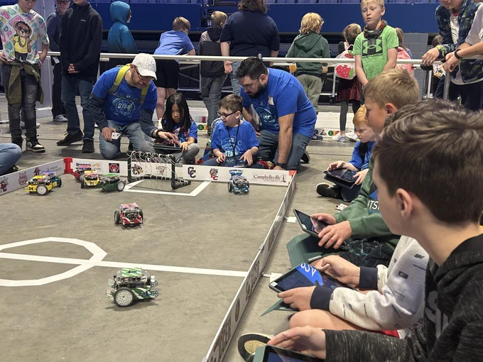 Kids using robots to soccer