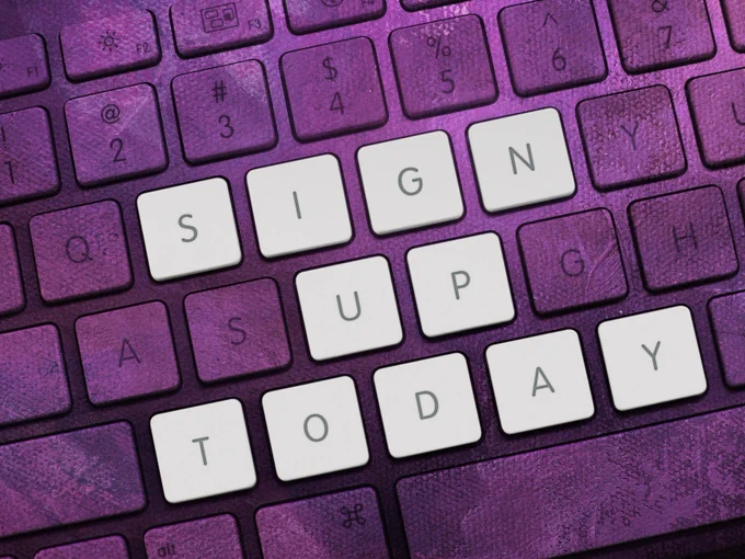 Image: Purple computer keyboard, white tiles read 'sign up today'