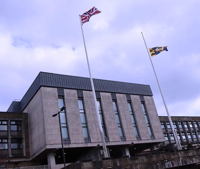 The Borough Flag flown at half-mast over Oldham Civic Centre.