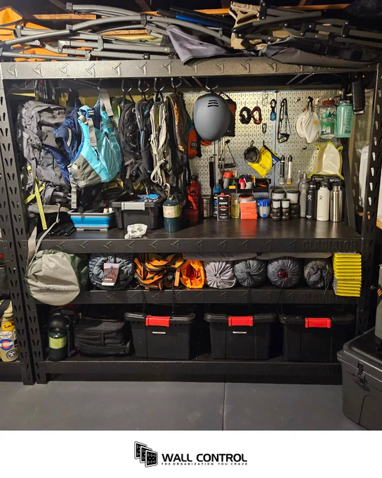 Outdoor gear is organized with silver metal pegboard panels made by Wall Control