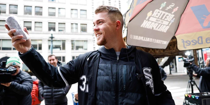 Gavin Sheets smiles as he holds up a hot dog