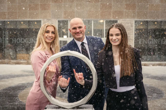Evelyn, Ian and Catherine all pose with their Iron Ring pinkies in the Iron Ring Statue