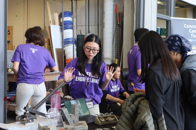 Photo of a Waterloo Engineering volunteering explaining their project to the visitors.