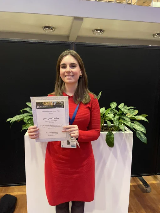 Image of the 2024 industrial group poster prize winner holding her certificate