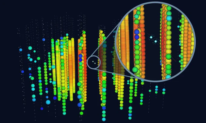 Strings of colored spheres depict the 3D array of detectors at the IceCube Observatory. 