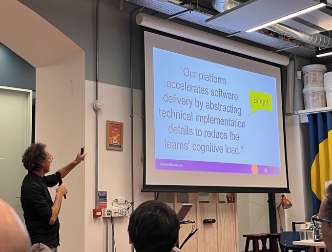Presenter gesturing at slide projection. 
Slide has ”Bingo” highlighted.